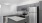 kitchen with grey cabinets, stainless steel appliances, and granite countertops