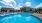 a swimming pool with a house in the background