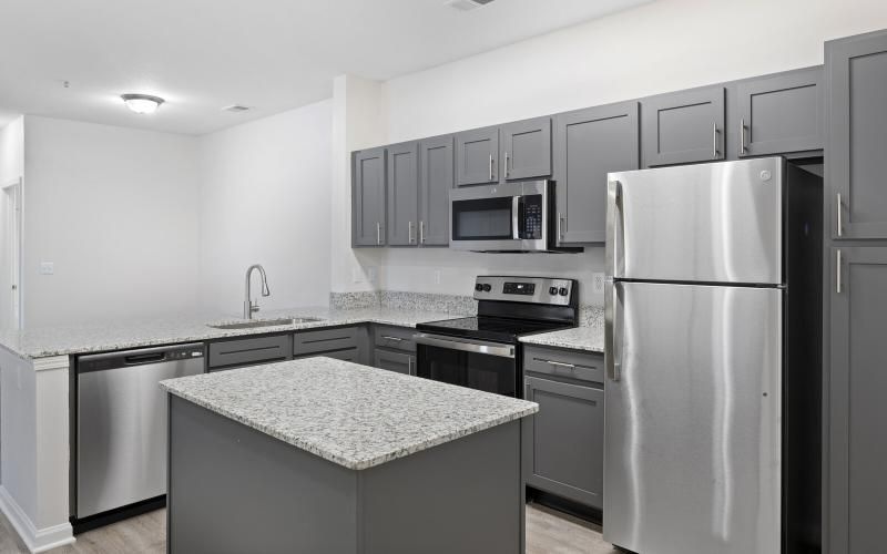 a kitchen with a refrigerator and microwave