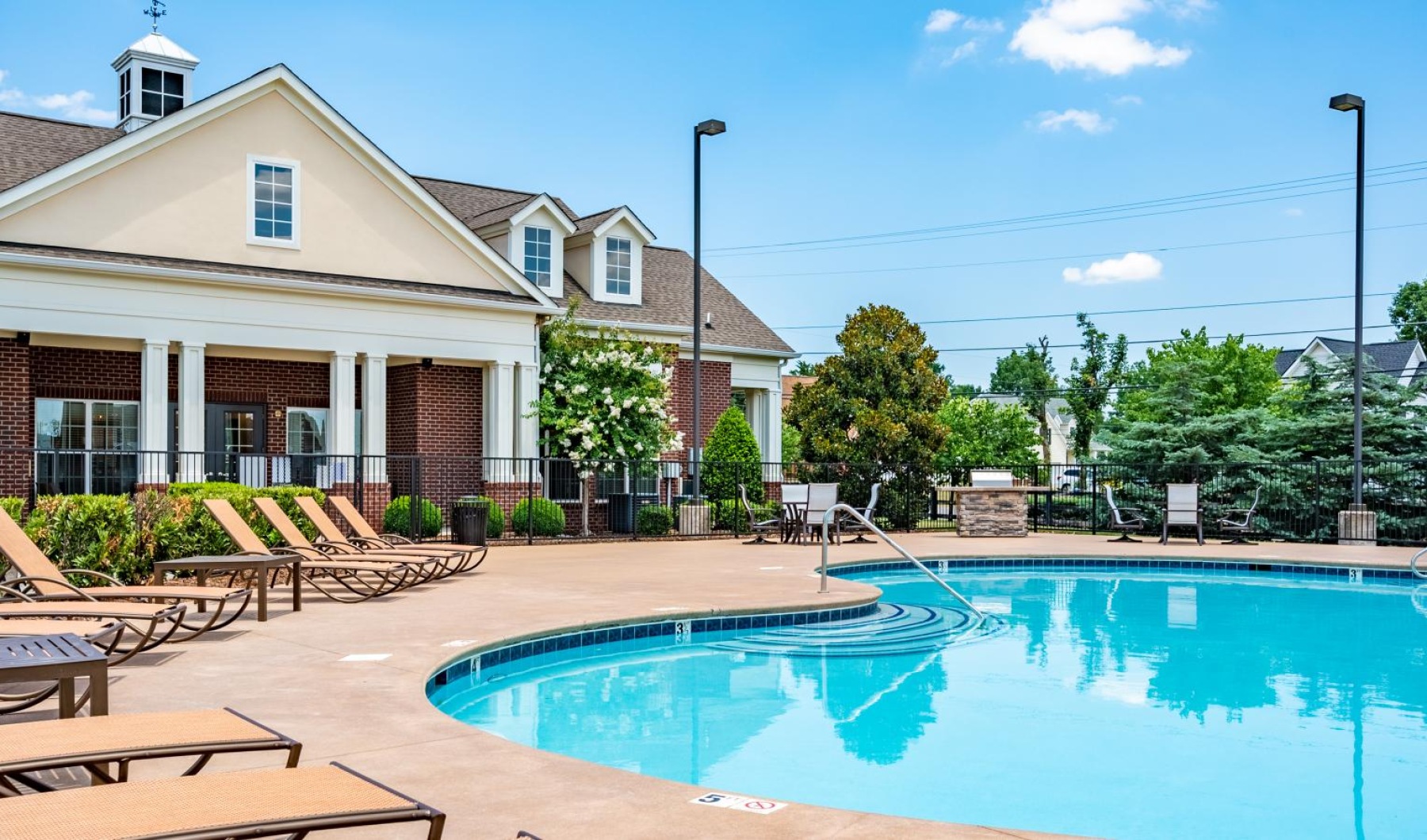 a swimming pool with chairs around it