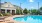 a swimming pool with chairs around it